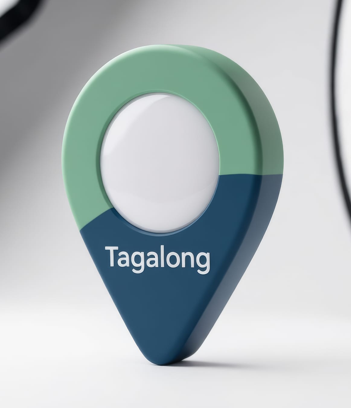 The Tagalong tag in its charcoal cradle, three-quarter studio view — a rounded map-pin shape in sage green and navy with a silver alligator clip.